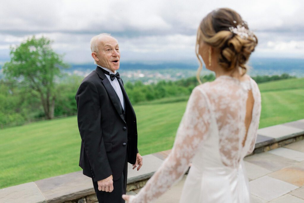 Father of bride with smile on face seeing his daughter in wedding gown for first time on spring Montalto wedding day