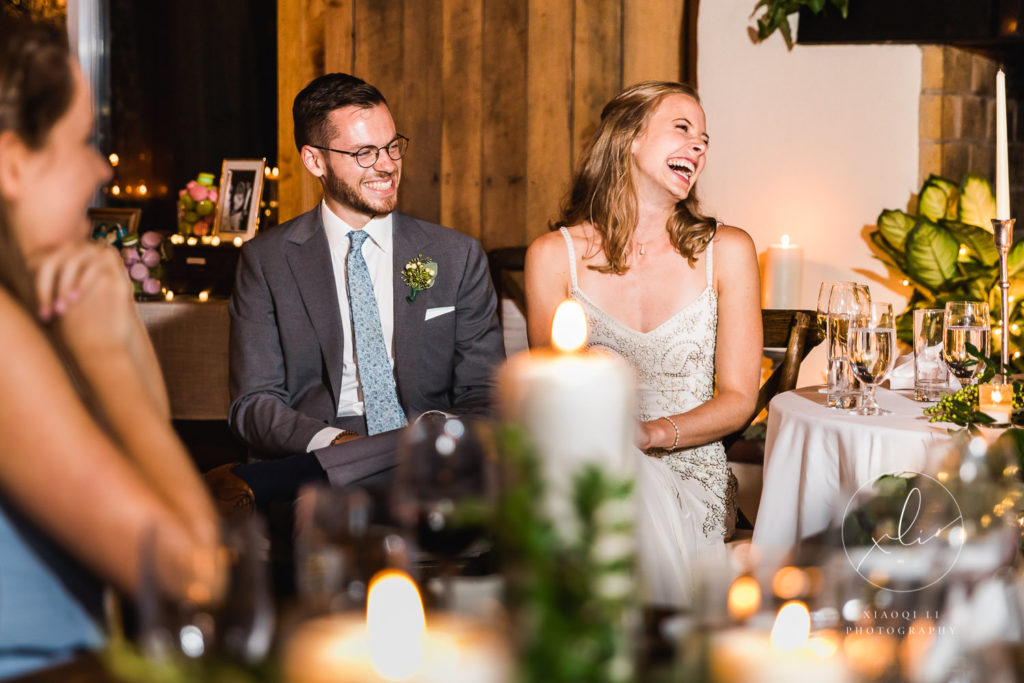 Couple laughing and smiling during wedding speeches