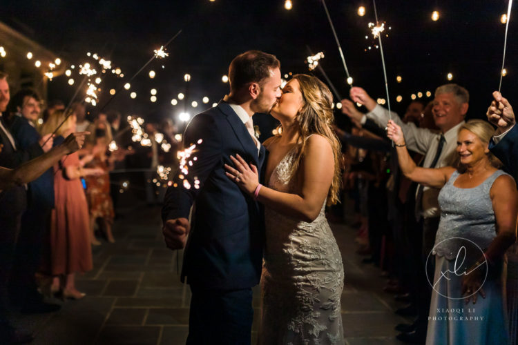 Couple sharing a kiss during their sparkler exit at Early Mountain Vineyards, photo by Xiaoqi Li Photography