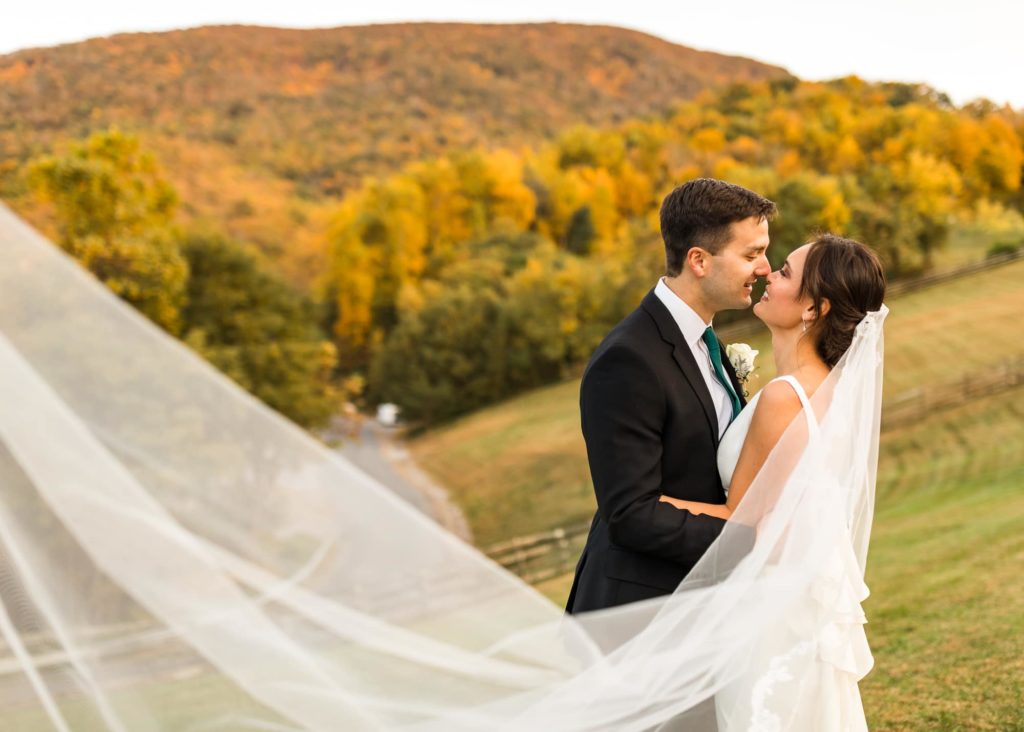 A couple in front of the fall foliage at House Mountain Inn