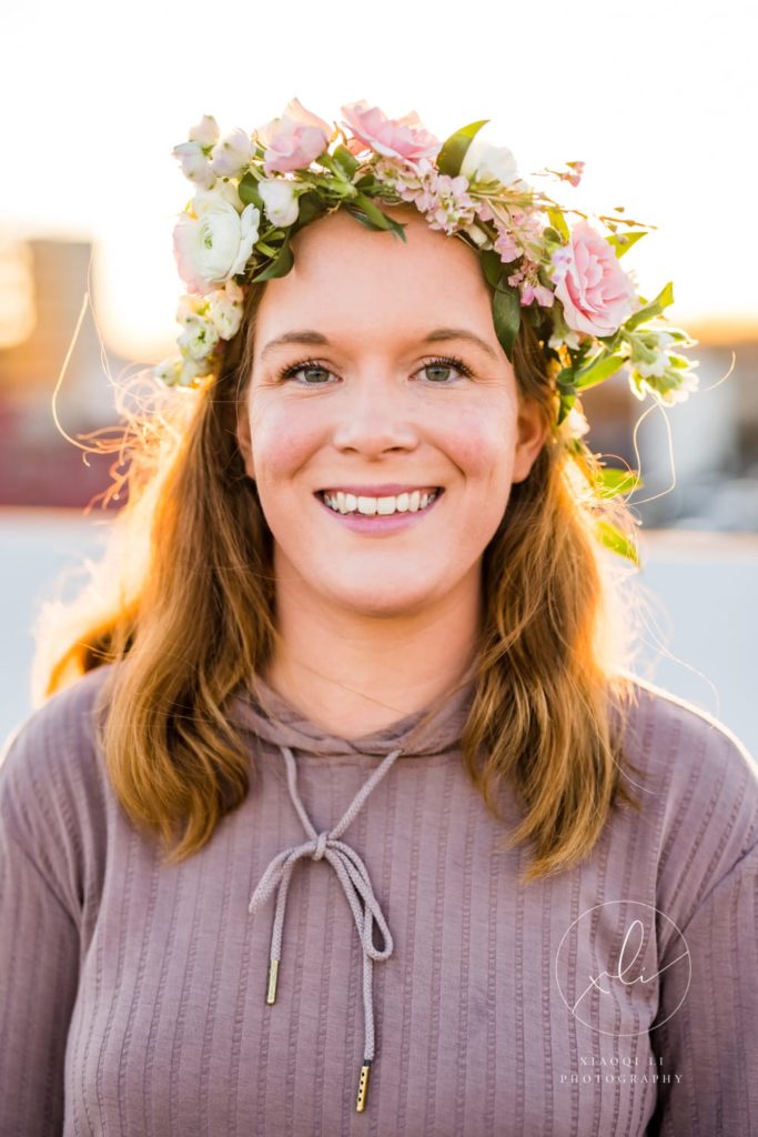 Kate, Charlottesville creator, and business owner wearing a floral crown supporting International Women's Day