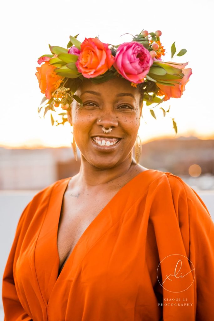 Charlottesville woman and business owner wearing floral crown celebrating international women's day