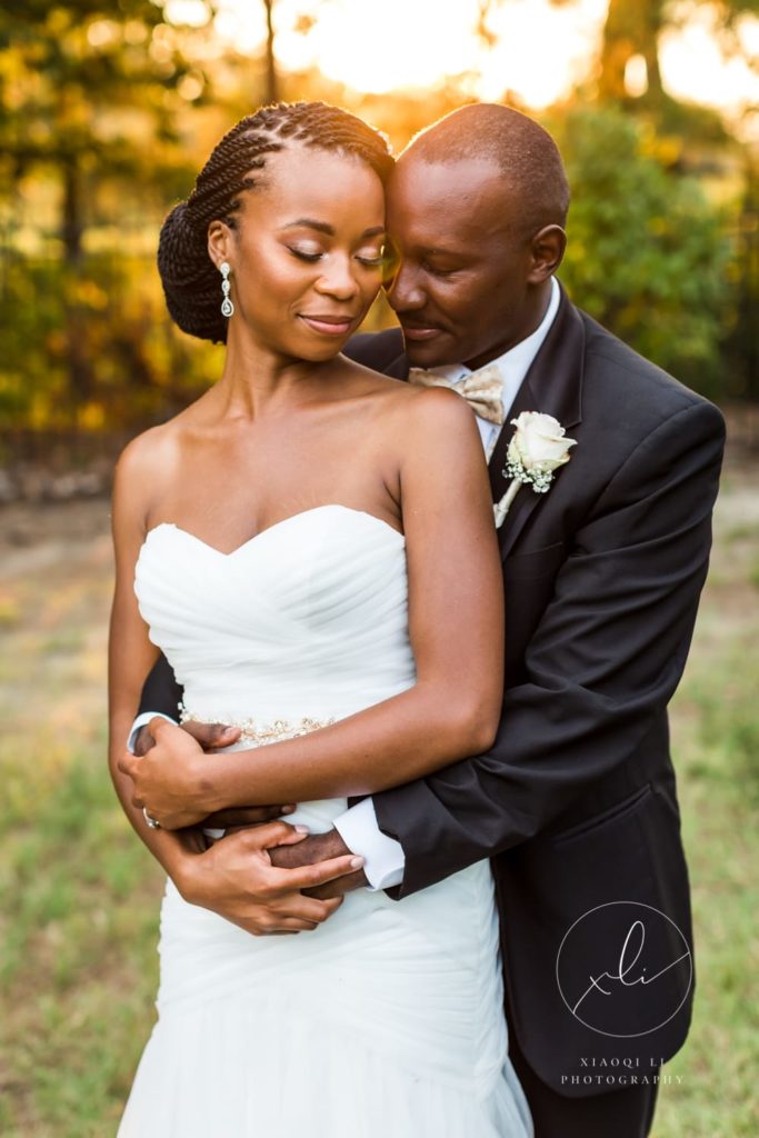 husband holding wife during portraits after ceremony