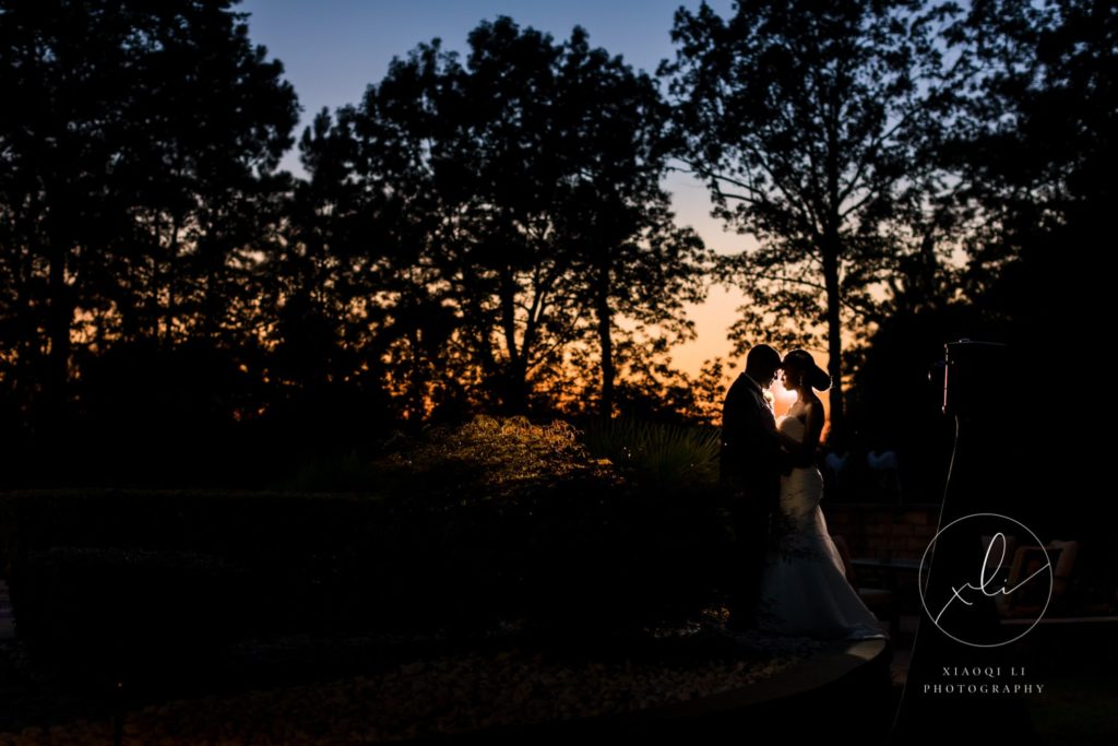 man and woman celebrating recent elegant backyard micro-wedding