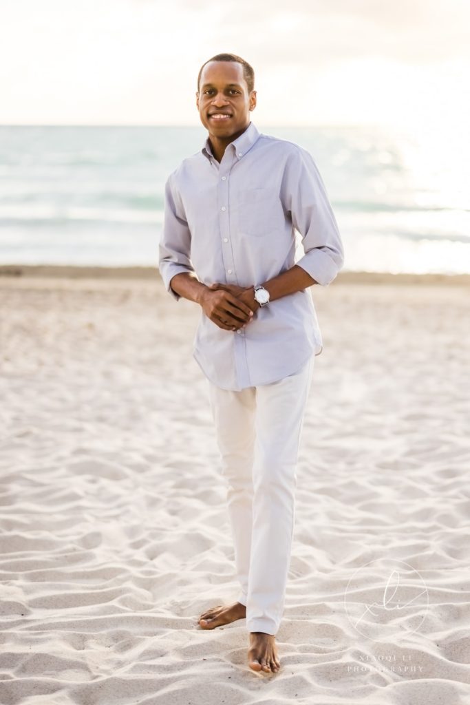 Man wearing blue shirt standing on beach