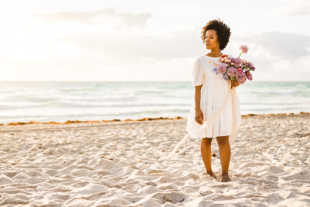 Woman holding engagement session bouquet while posing 