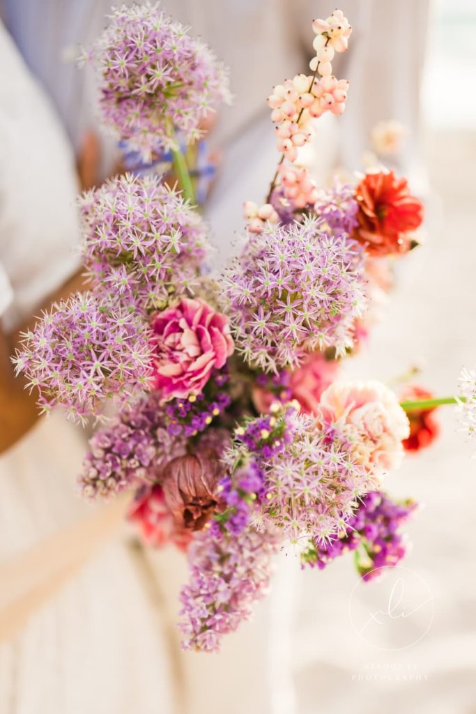 engagement session bouquet with purple and pink flowers