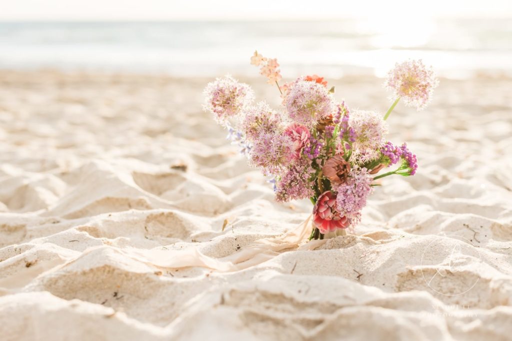 Engagement session bouquet stuck in sand
