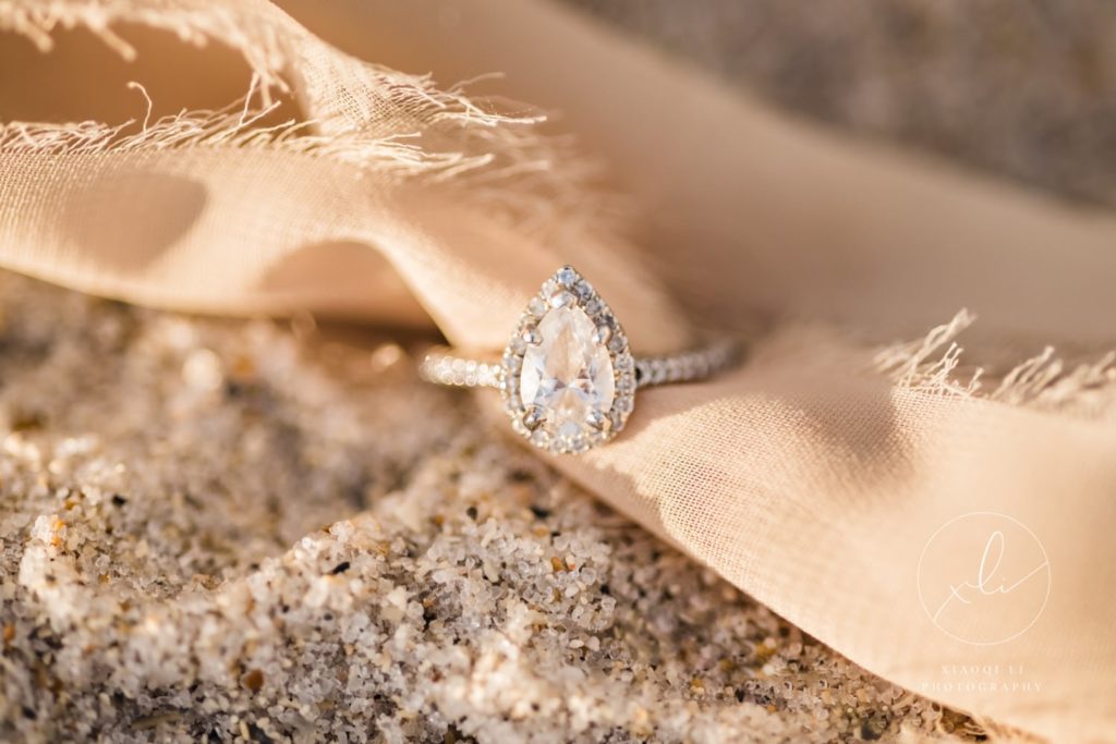 engagement ring styled with ribbon and sandy beaches of Miami during engagement session