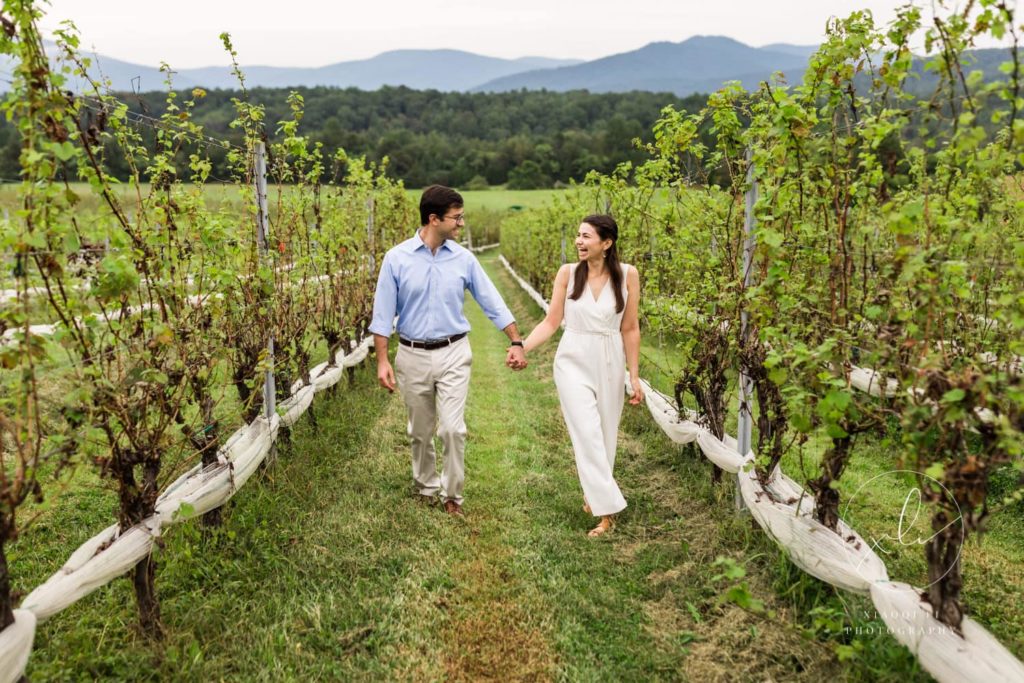 engaged couple walking through Stinson Vineyards