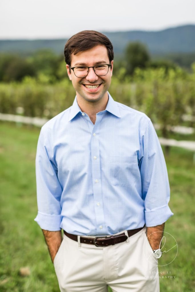 man smiling during spring vineyard engagement session