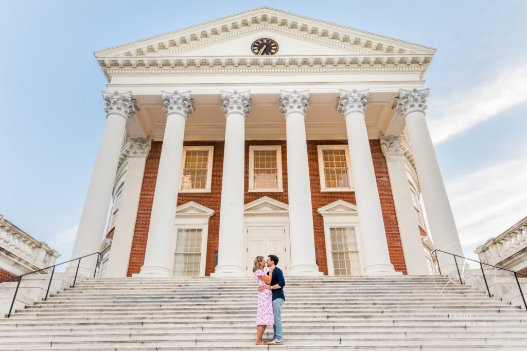newly engaged couple kissing in front of university of virginia