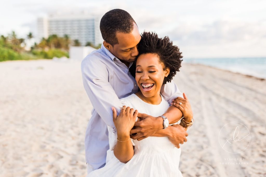 Couple embracing on the beach in Florida during outdoor engagement session