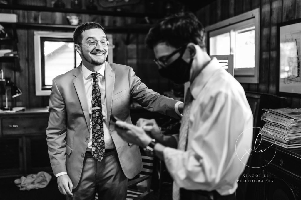 Groom laughing and joking with friends before episcopal wedding