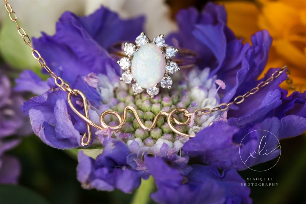 detail shot of wedding ring on purple flower