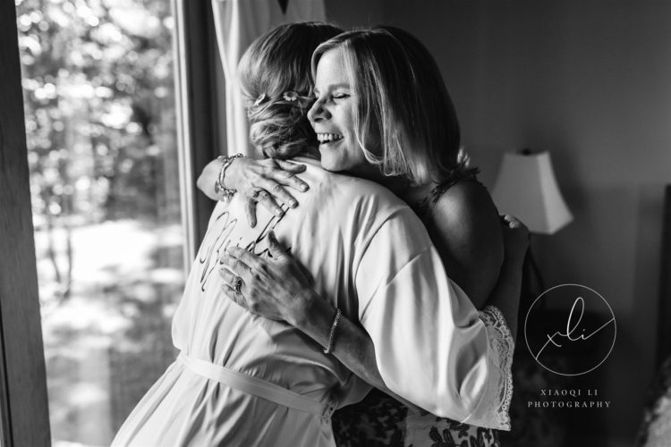 Bride hugging family while getting ready for wedding