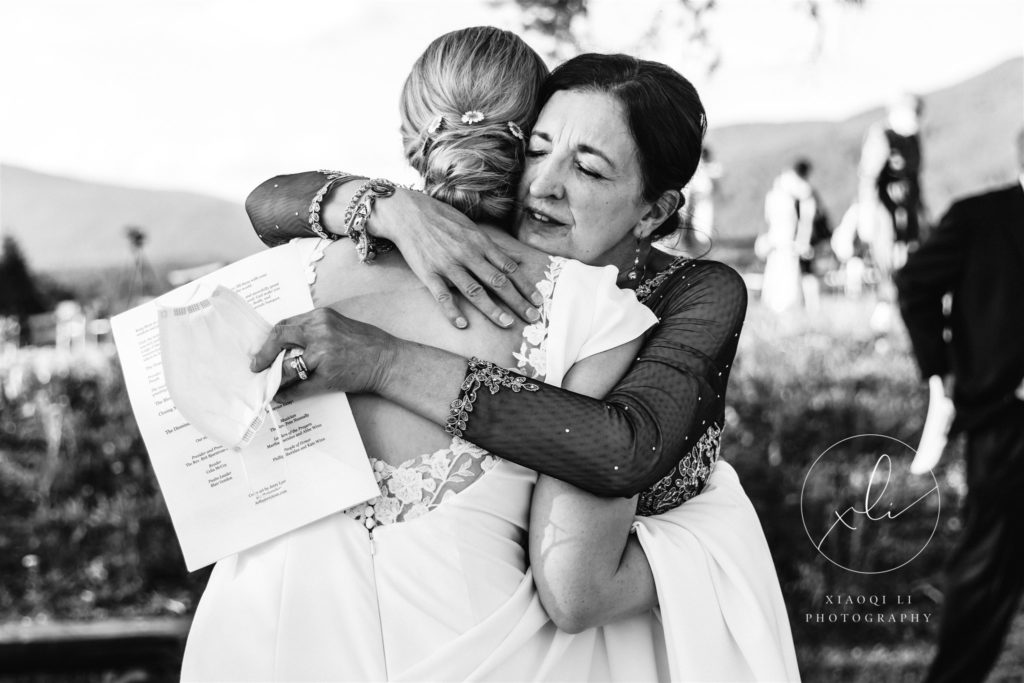 Bride hugging friend after ceremony