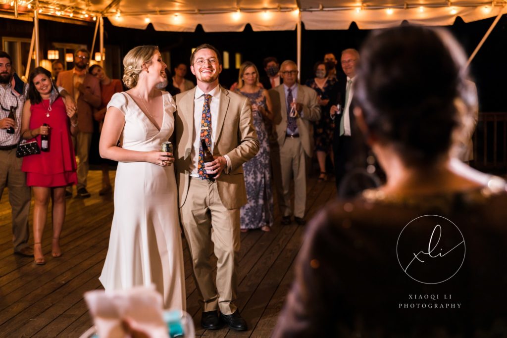 Couple laughing together and enjoying toasts at wedding reception
