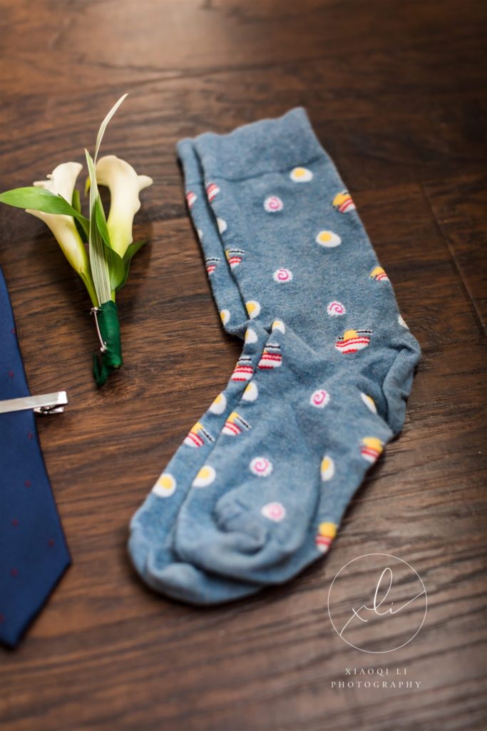 blue dress socks and boutonniere detail shots on wedding day before tea ceremony