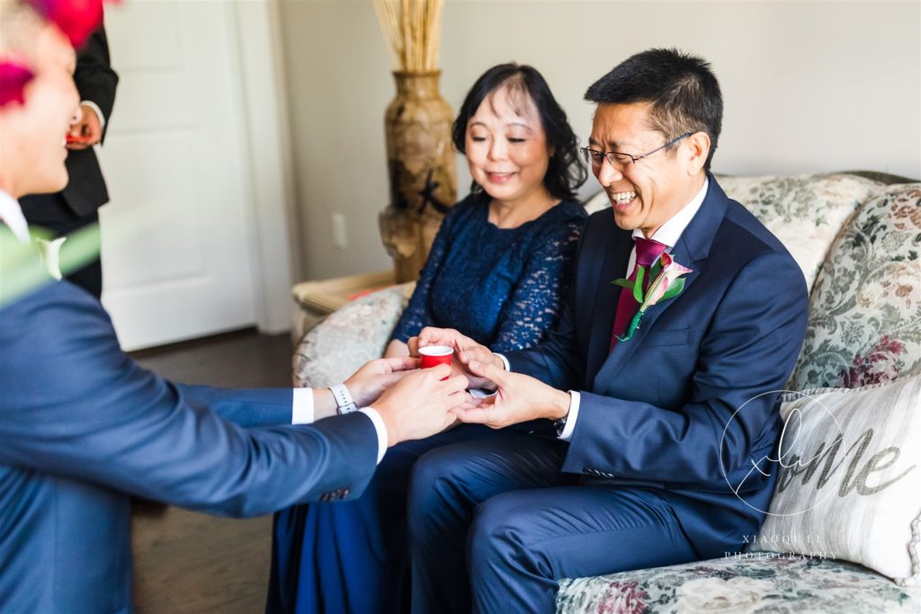 Parents of couple giving them gifts and advice on wedding day