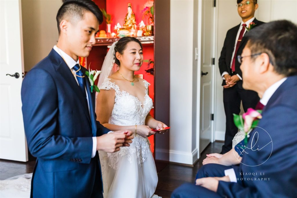 Couple kneeling in front of parents during tea ceremony at Richmond wedding