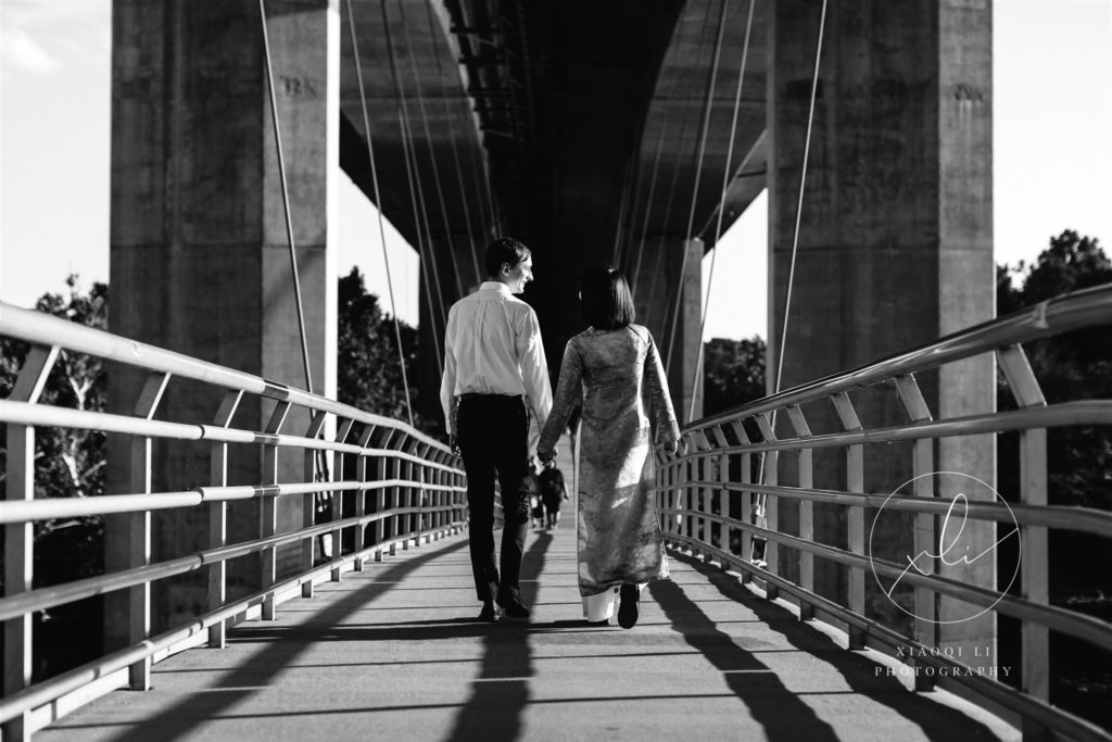 newly engaged couple walking during ao dai engagement session