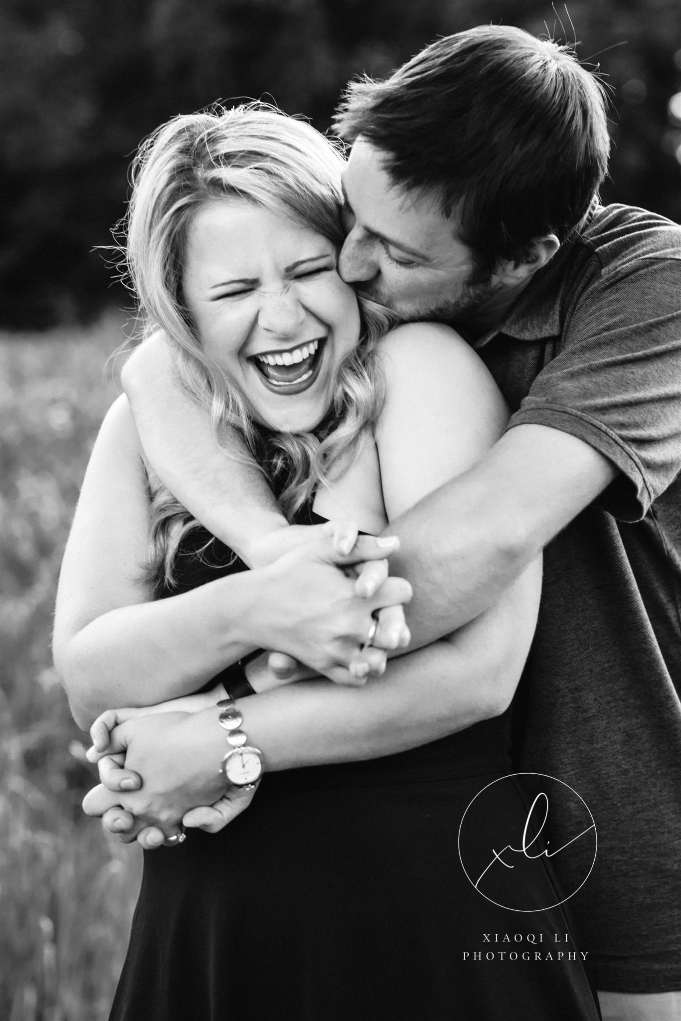 man hugging woman and laughing during outdoor session