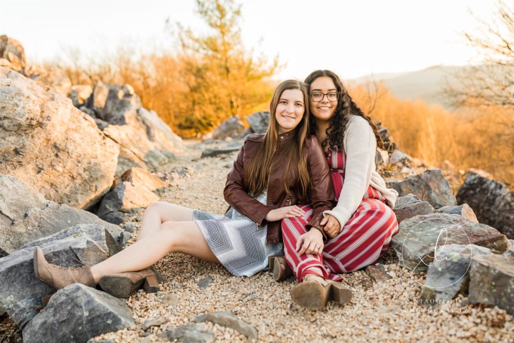 Emily and Sophie sitting on ground during engagement session