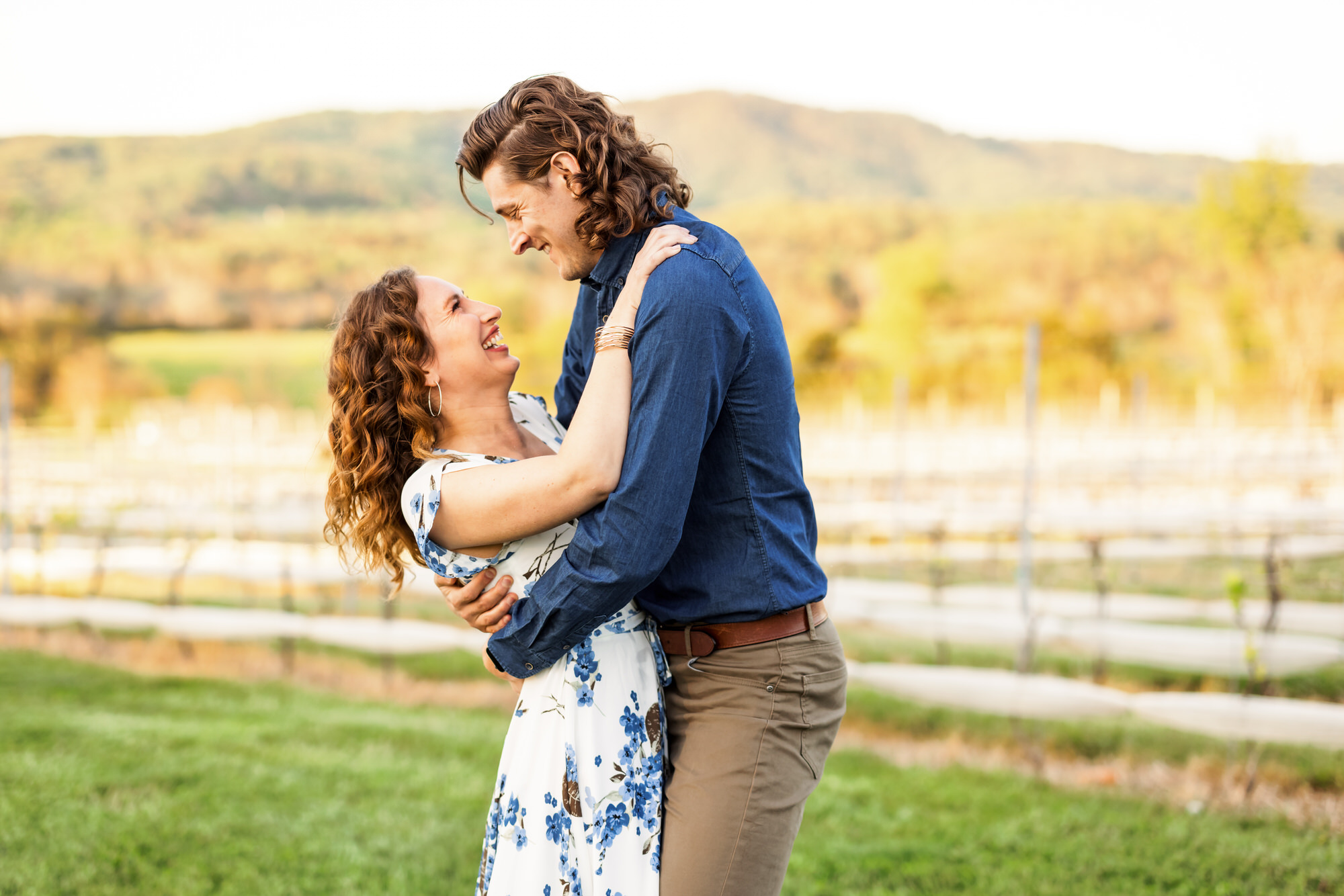 couple hugging and smiling during Stinson Vineyard engagement session