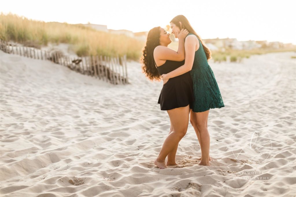 Newly engaged couple hugging on the beach during outdoor shoot