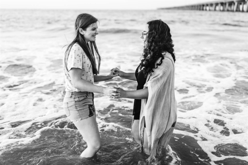 Emily and Sophie in the water at Chick's beach during engagement session