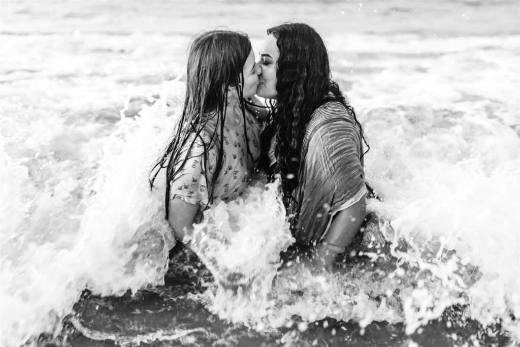 Emily and Sophie kissing in the water
