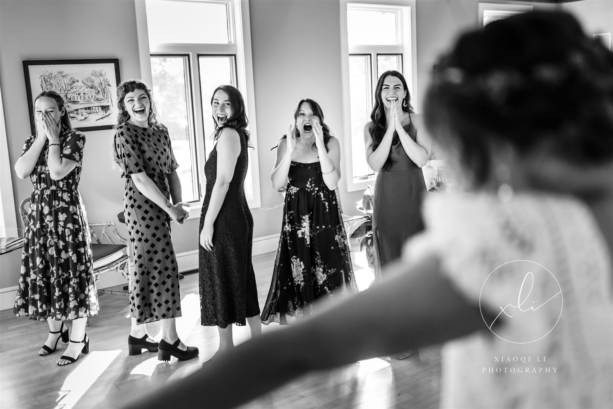 Bride during first look with bridesmaids and friends