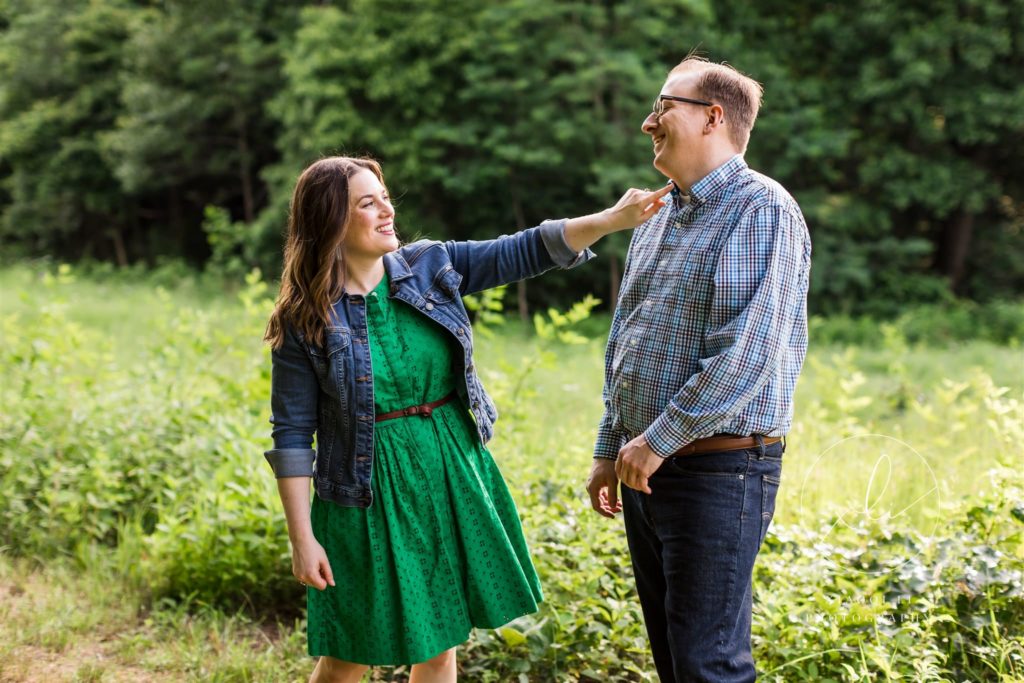 man and woman laughing and joking during engagement session