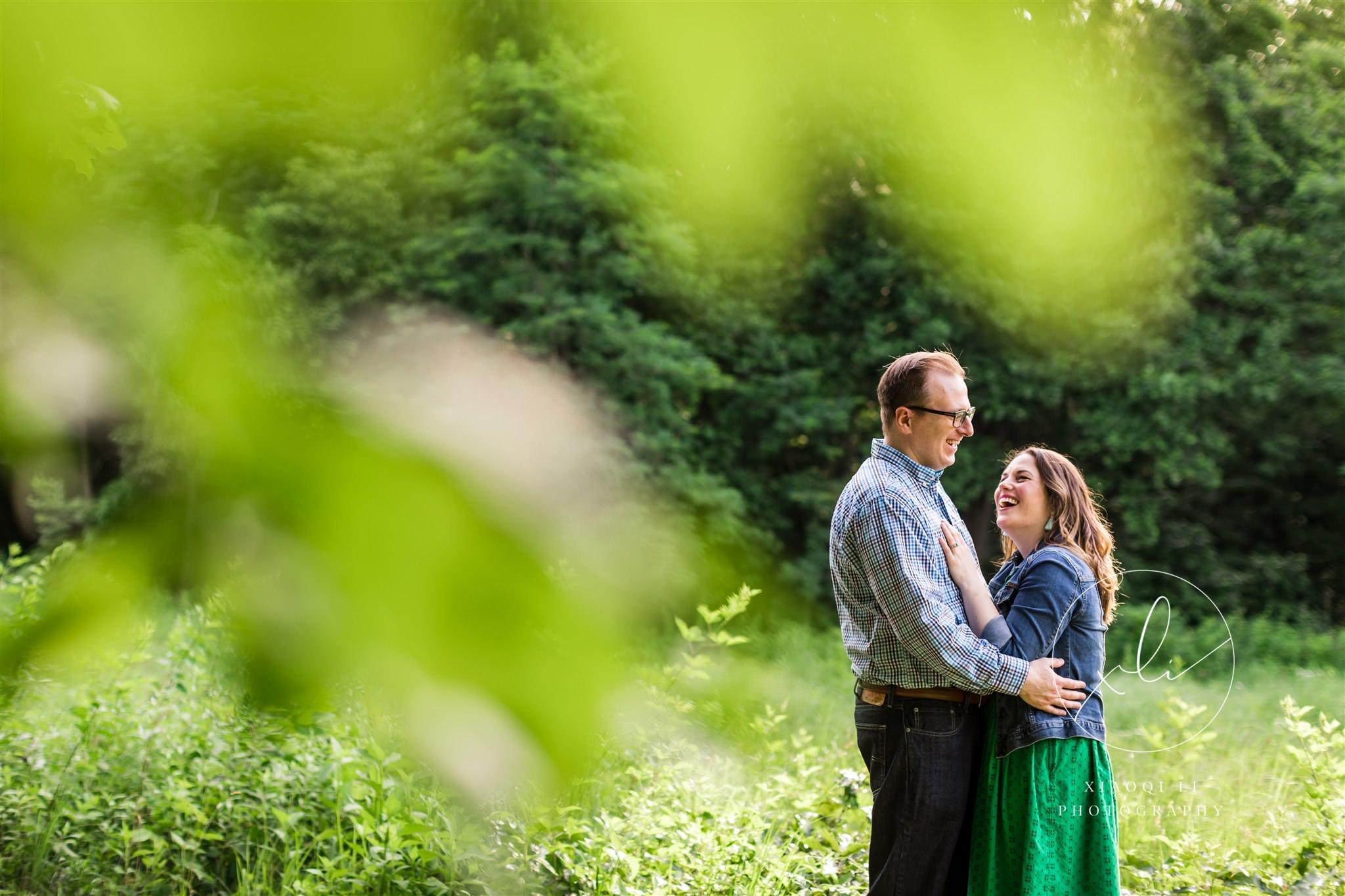 engaged couple hugging outdoors at ivy creek natural area center