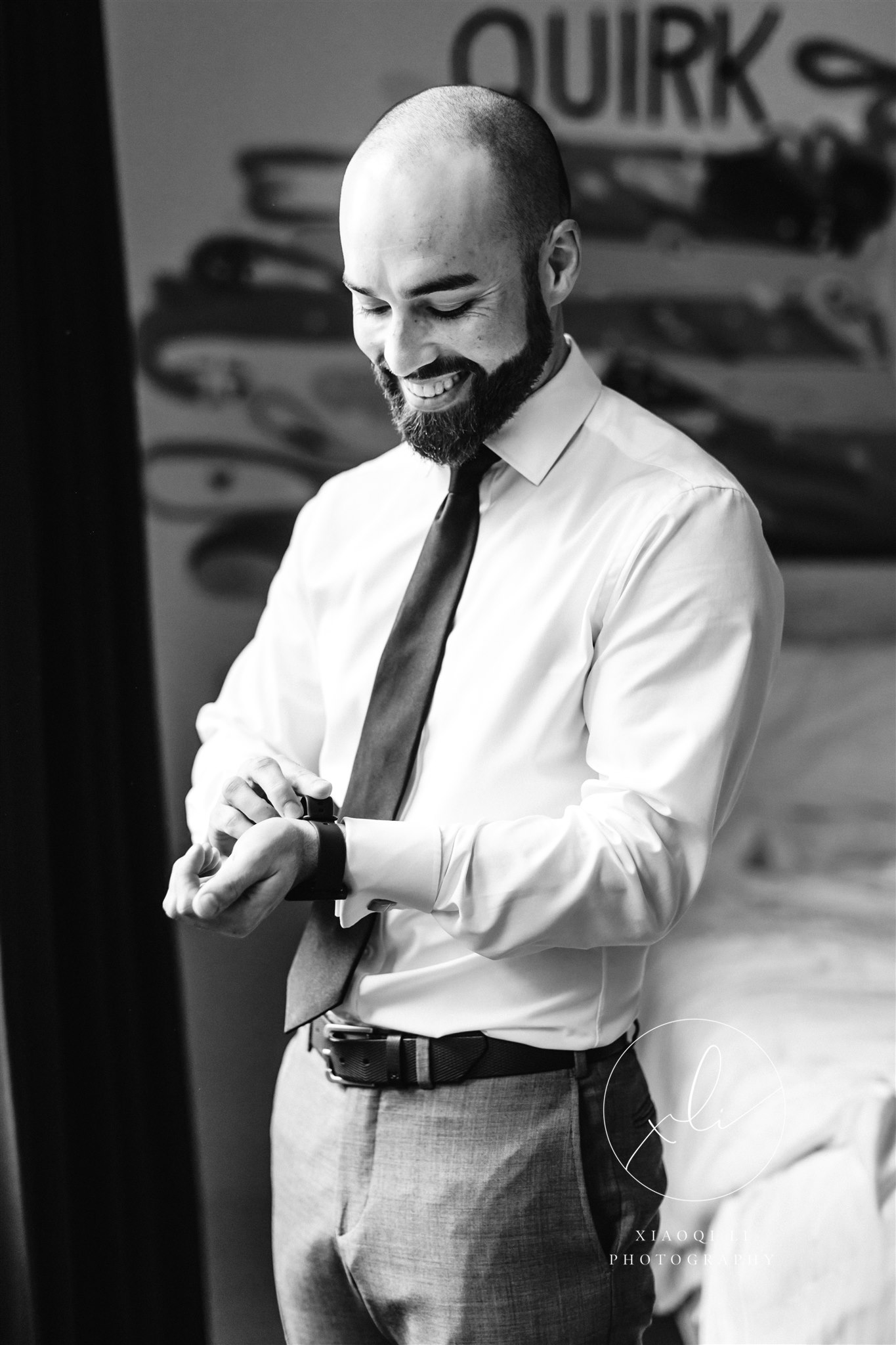 Groom putting watch on before morning wedding ceremony in Virginia