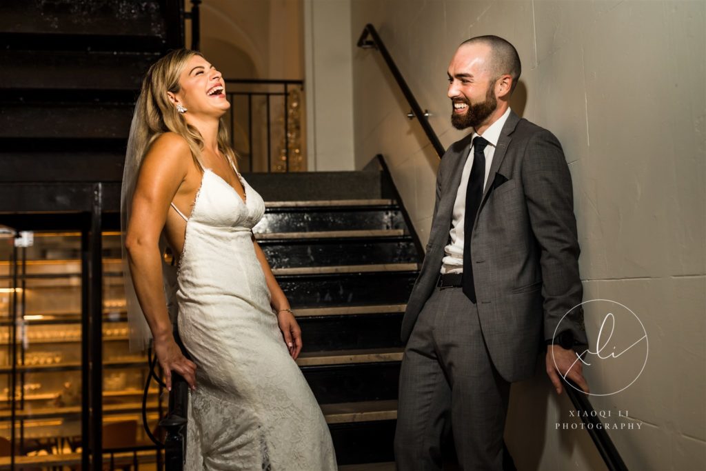 Newly married couple hanging out in hallway in Quirk Hotel laughing