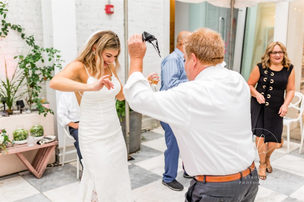 Bride dancing with guests at brunch wedding reception