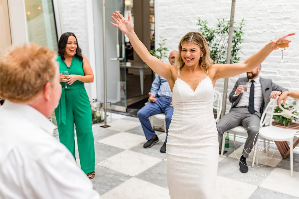 Bride laughing and dancing during reception during Richmond wedding