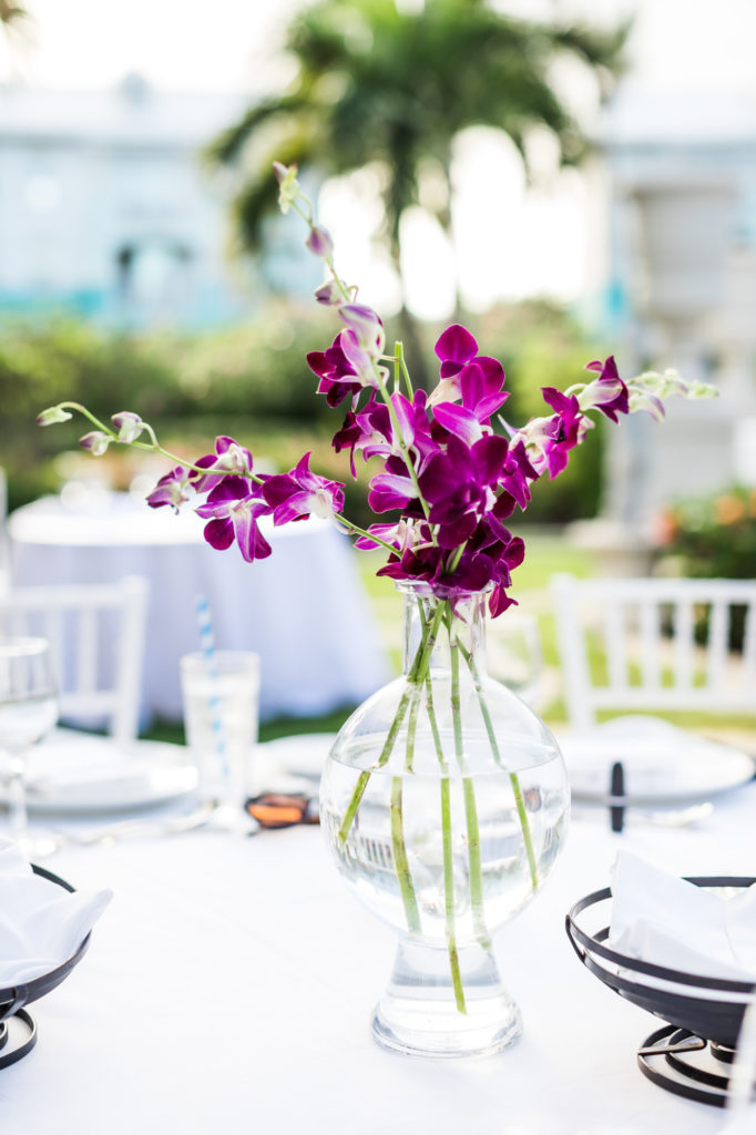 table centerpieces with purple orchids in clear vase