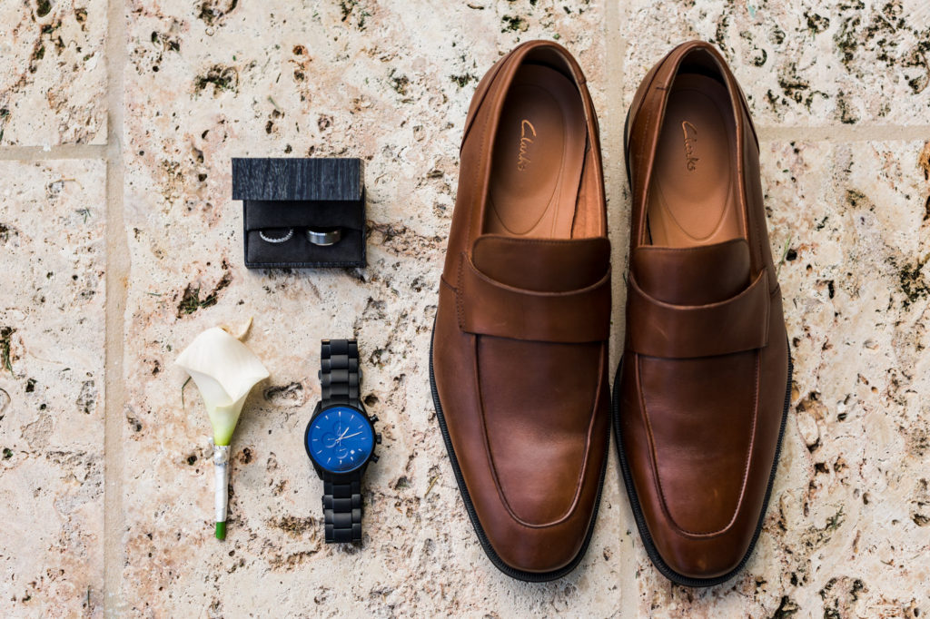 Wedding details of groom's shoes, watch, and other details