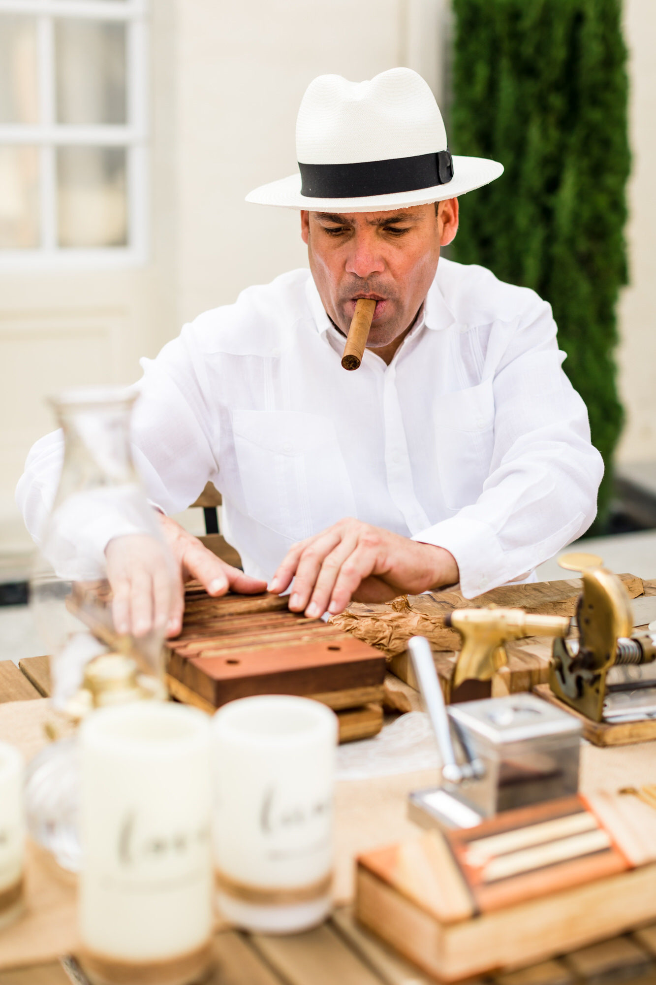 cigars being rolled in traditional manner at cuban inspired wedding