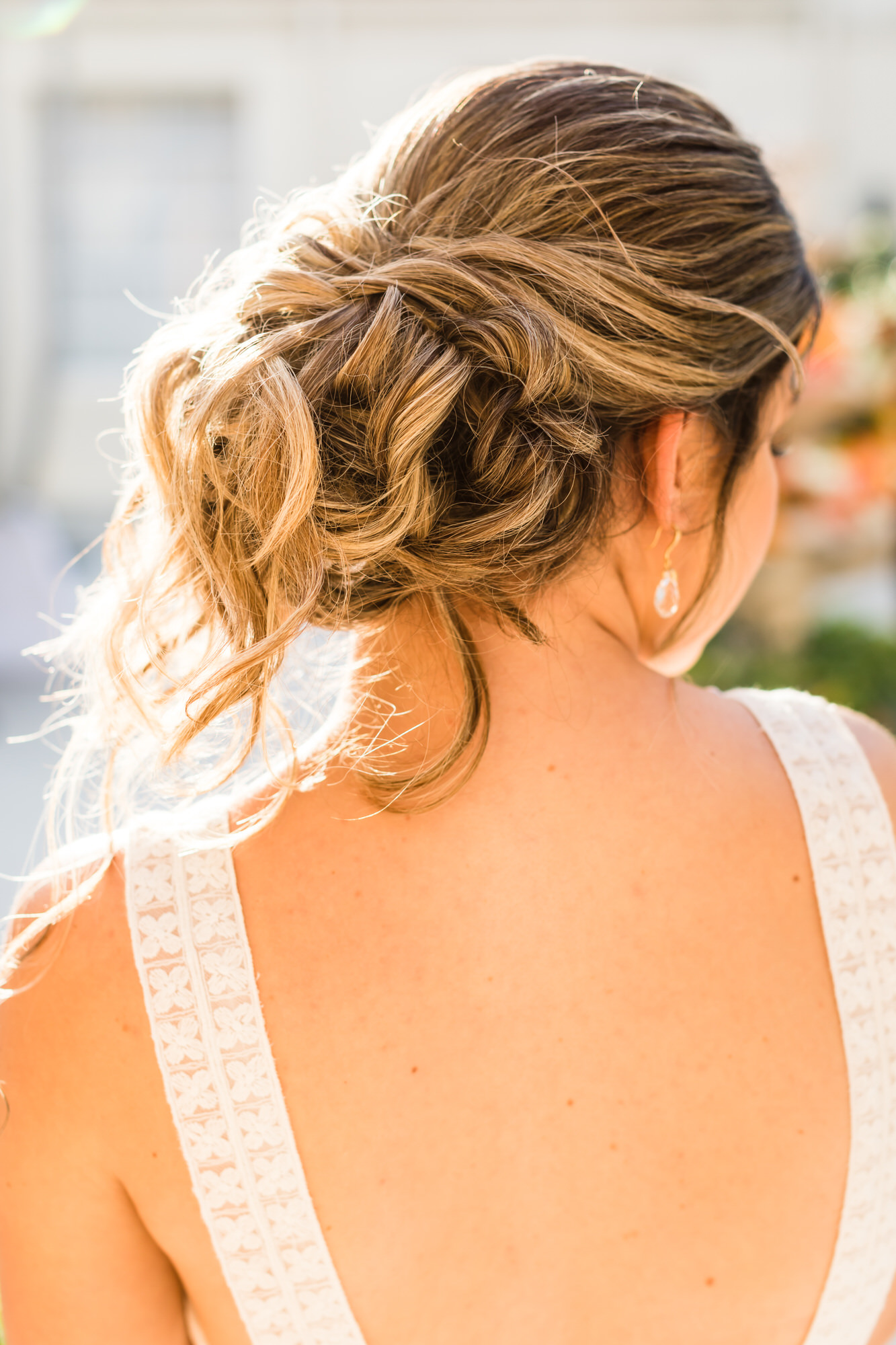 bridal hairstyle with loose bun in curls with face framing face