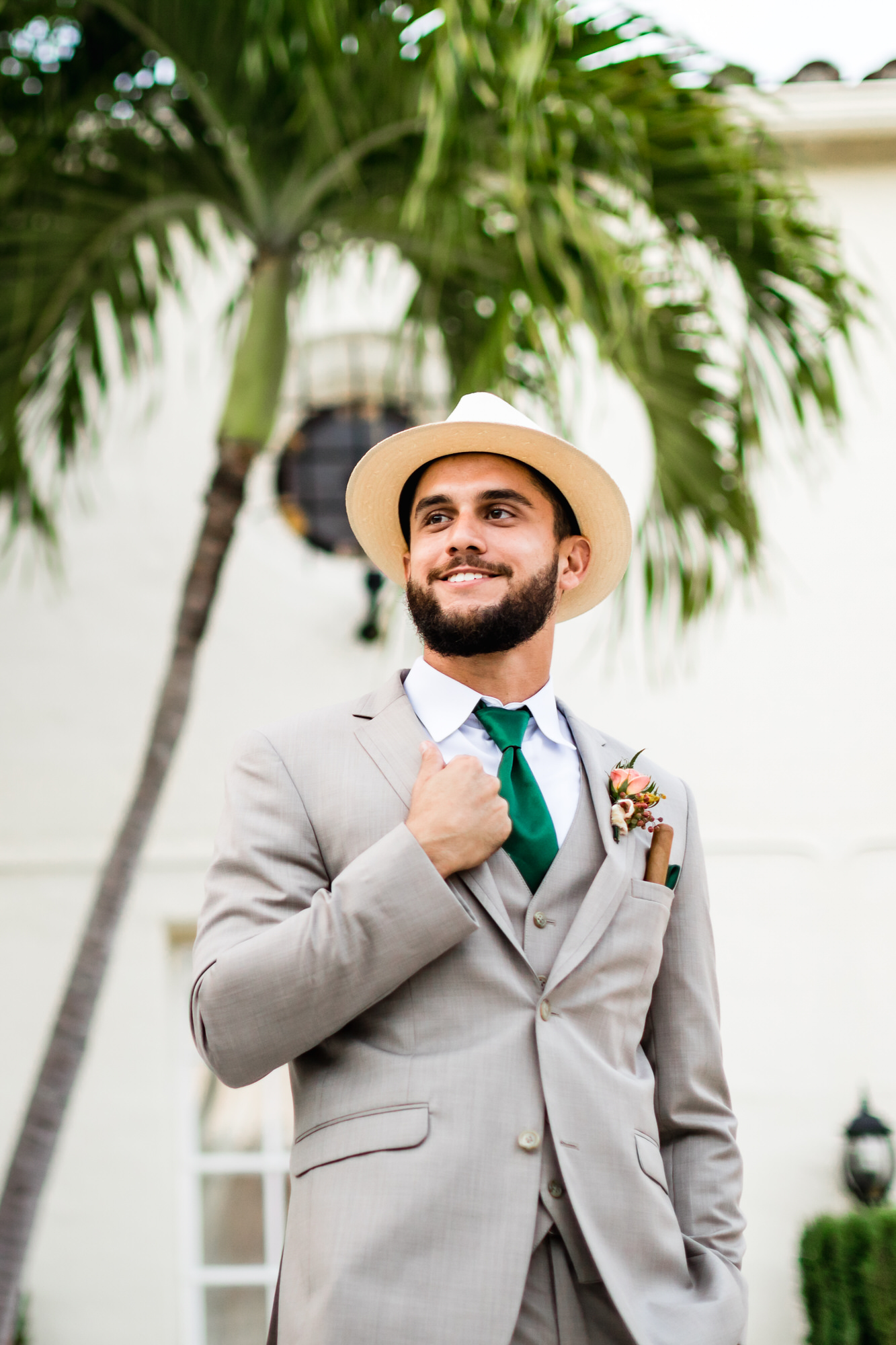 groom wearing cream fedora and grey suit at miami florida wedding