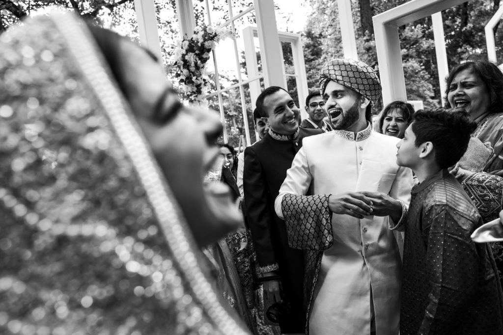couple laughing and having fun with family and friends during wedding celebrations