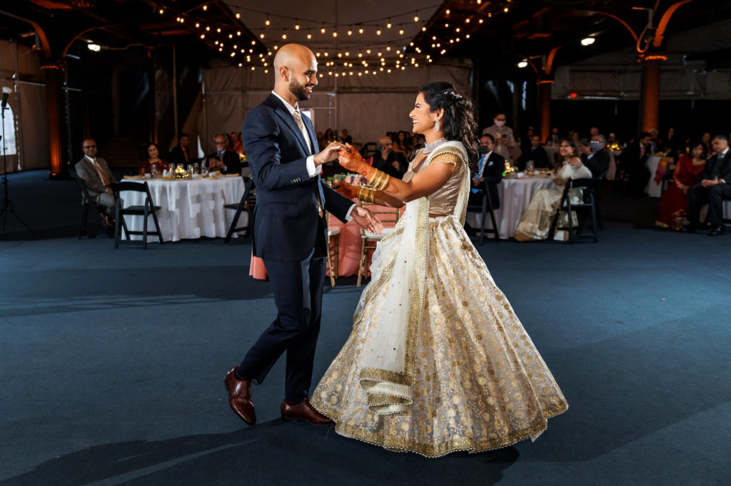 newly married couple dancing as husband and wife on wedding day at hindu muslim interfaith wedding