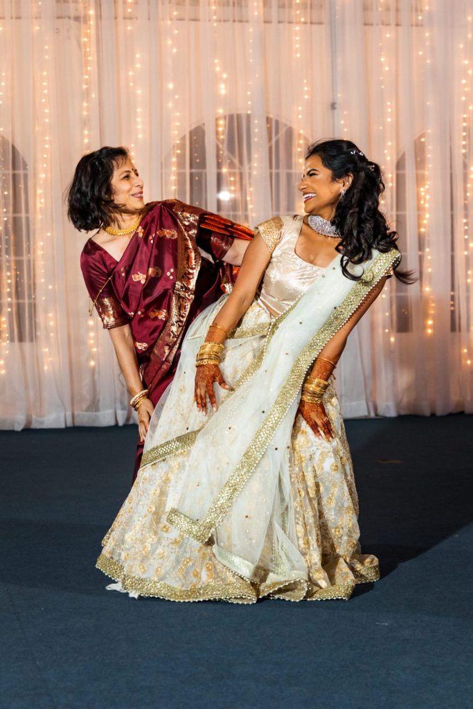 bride dancing with mother on wedding day during reception