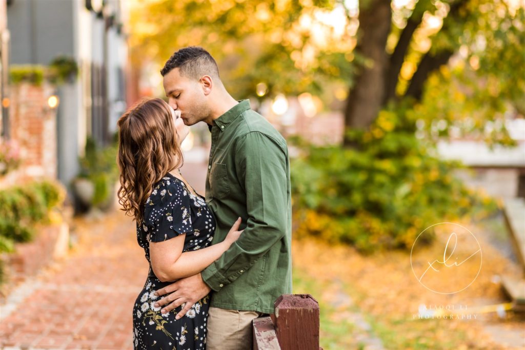 man and woman kissing in Georgetown during fall session