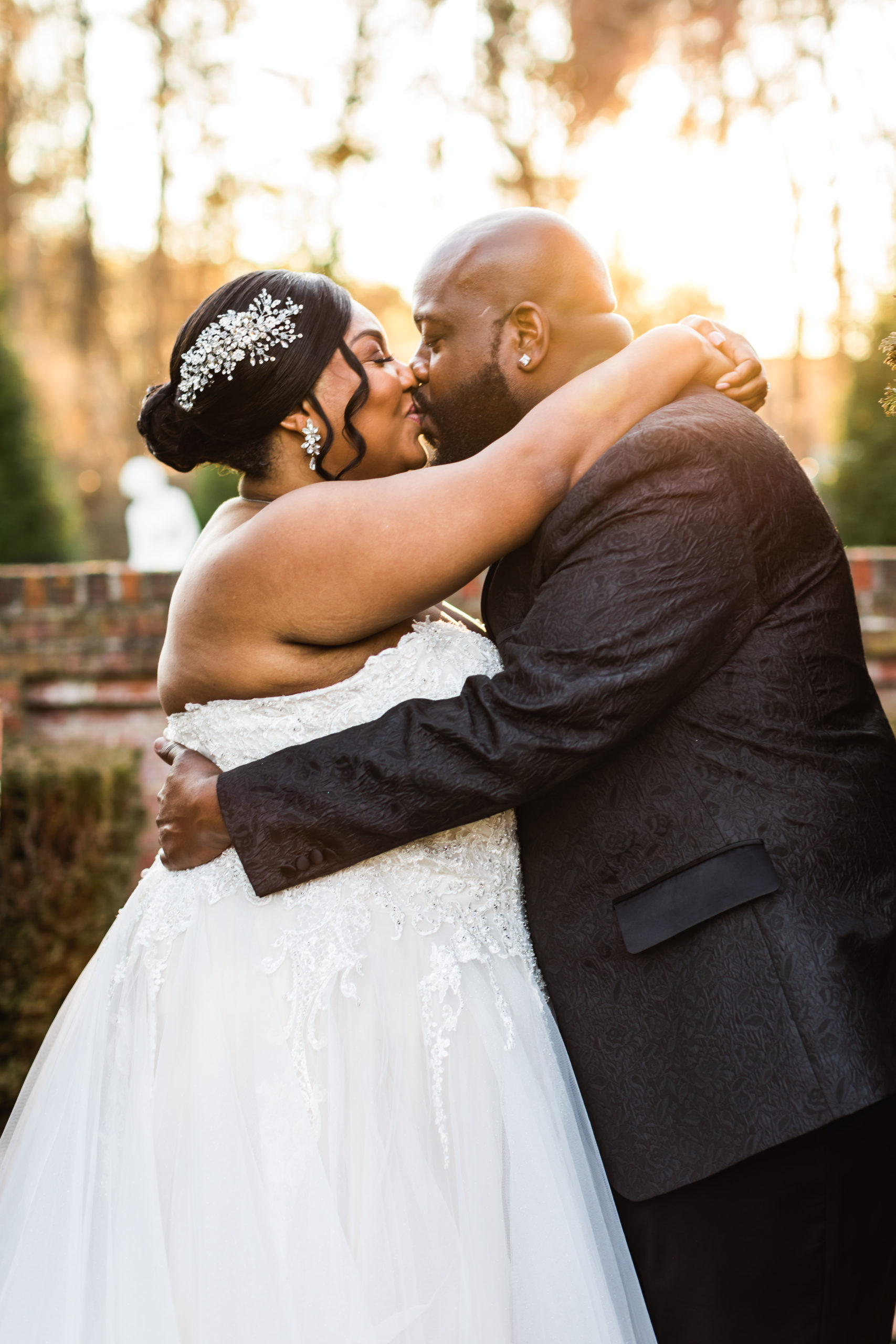 bride and groom kiss in celebration of mankin mansion wedding day