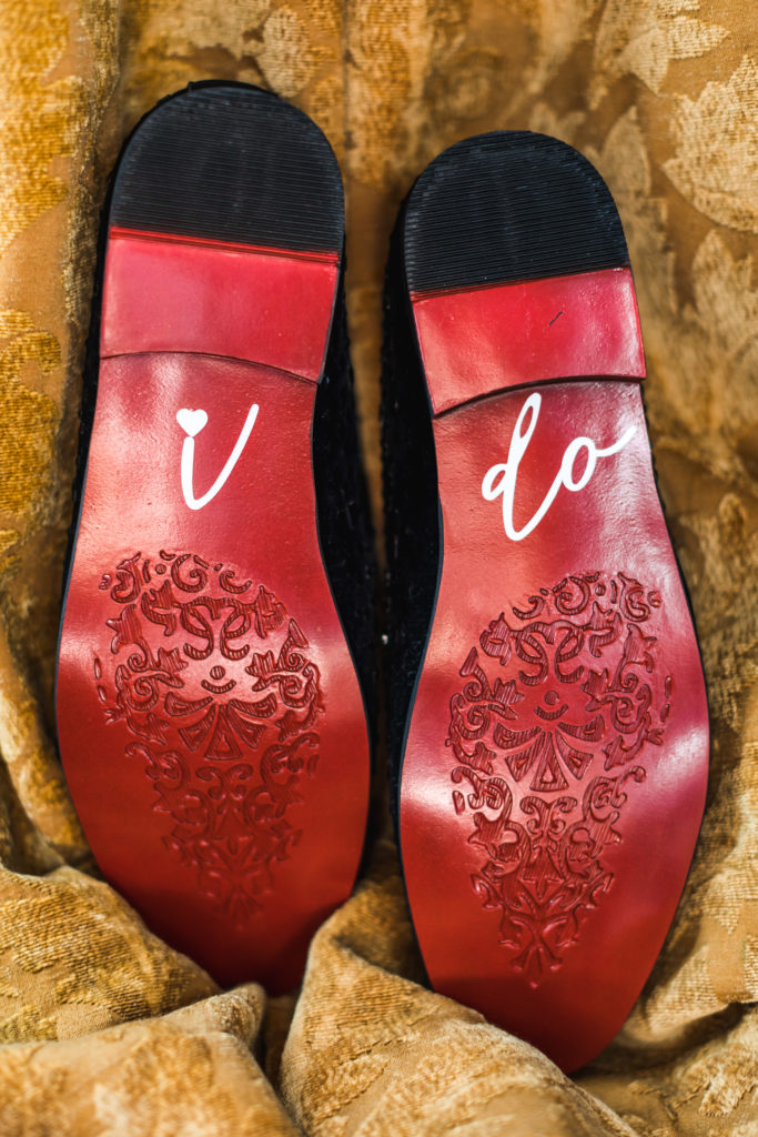 groom's shoes with personalized 'I do' on bottom of red soled shoes